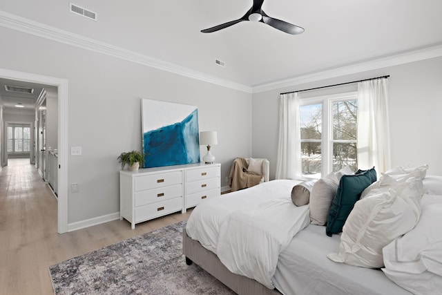 bedroom with multiple windows, visible vents, and vaulted ceiling