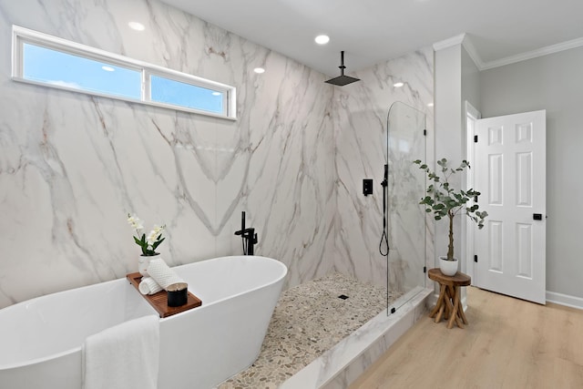 full bath featuring a freestanding tub, crown molding, a marble finish shower, and wood finished floors