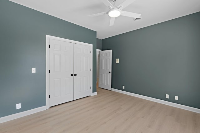 unfurnished bedroom with visible vents, baseboards, a ceiling fan, light wood-style floors, and a closet