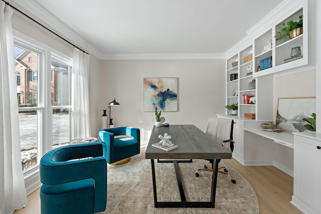 home office with light wood-style floors and crown molding