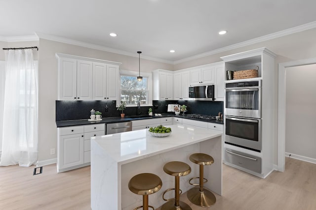 kitchen with white cabinets, stainless steel appliances, and a warming drawer