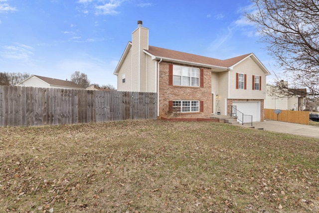 view of front of house with a garage and a front lawn