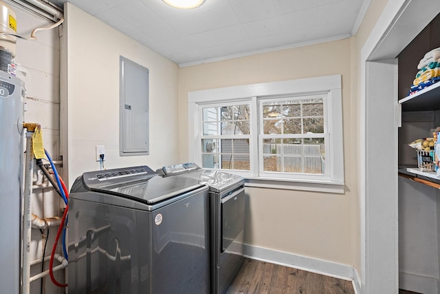 laundry area featuring washing machine and clothes dryer, ornamental molding, dark hardwood / wood-style flooring, and electric panel