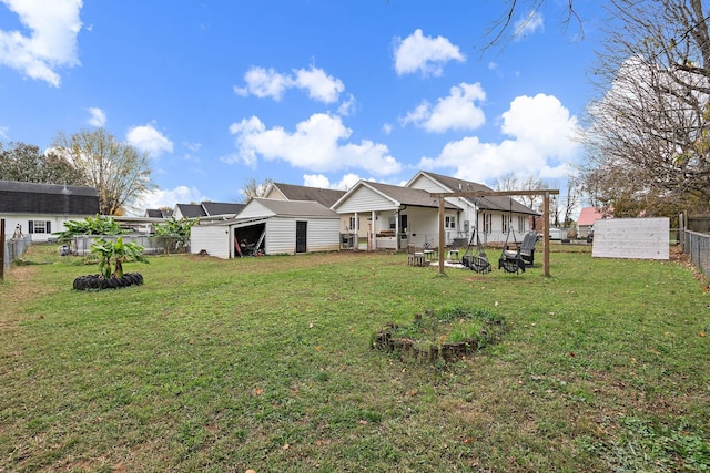 rear view of house featuring a lawn