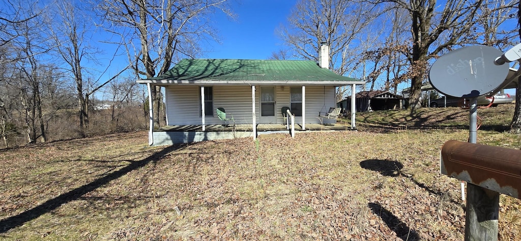 exterior space with a porch and a front lawn