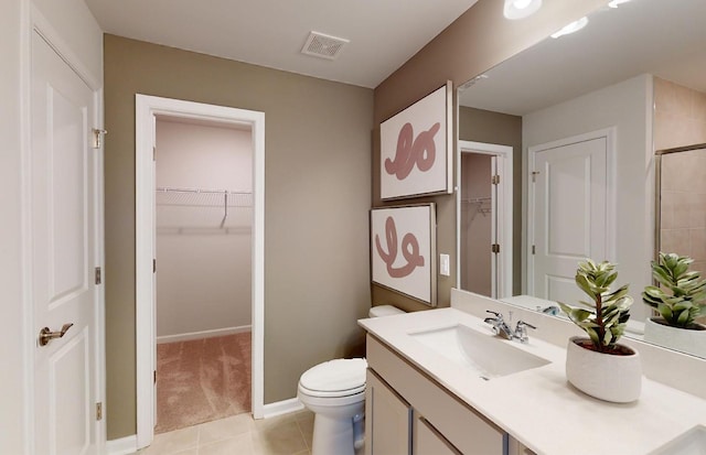 bathroom with vanity, toilet, an enclosed shower, and tile patterned flooring