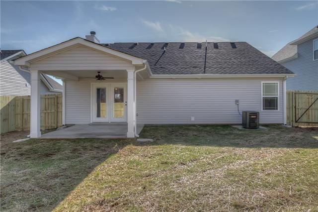 back of property featuring a lawn, ceiling fan, a patio, central AC unit, and french doors