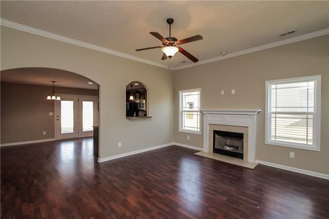 unfurnished living room with dark hardwood / wood-style flooring, a high end fireplace, ornamental molding, and ceiling fan