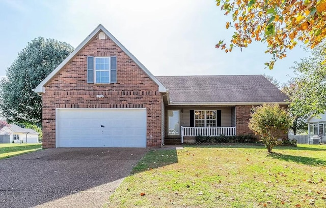 view of front of house with a garage, covered porch, and a front yard