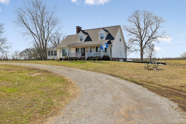 cape cod-style house with covered porch and a front lawn