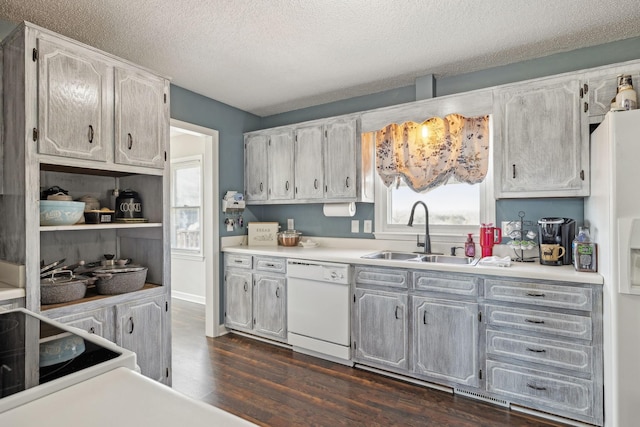 kitchen featuring sink, a textured ceiling, range with electric stovetop, dark hardwood / wood-style flooring, and dishwasher