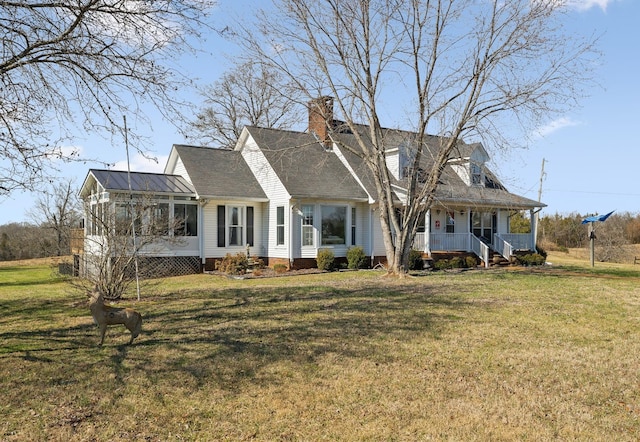 cape cod house featuring a porch, a front lawn, and a sunroom