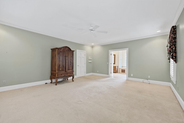 carpeted empty room with ceiling fan and ornamental molding