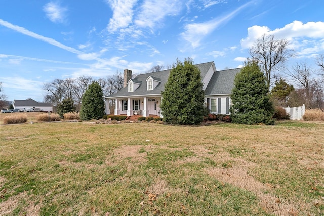 cape cod home featuring covered porch and a front lawn