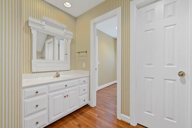 bathroom with vanity and hardwood / wood-style flooring