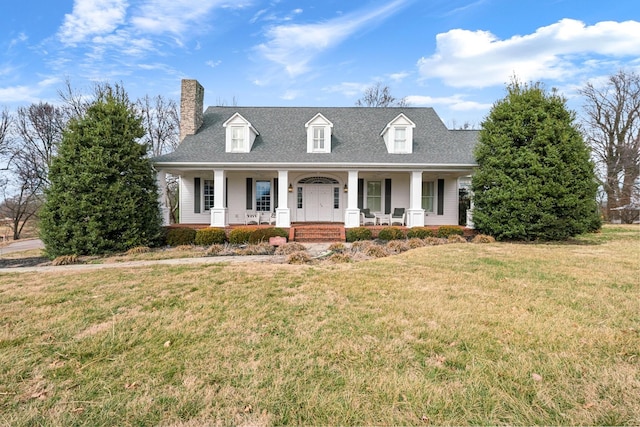 new england style home featuring a porch and a front yard