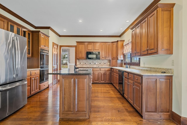 kitchen with backsplash, a kitchen island, black appliances, stone countertops, and dark hardwood / wood-style flooring