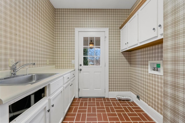 laundry room featuring cabinets, hookup for a washing machine, and sink