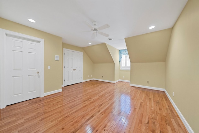 additional living space featuring vaulted ceiling, ceiling fan, and light hardwood / wood-style flooring