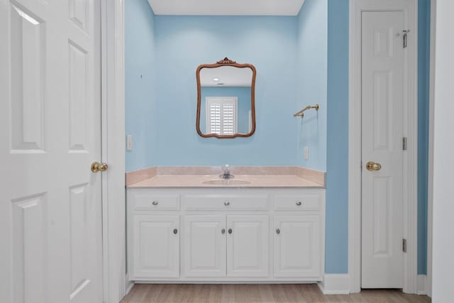 bathroom featuring vanity and hardwood / wood-style flooring