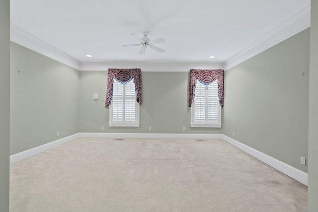 spare room with crown molding, plenty of natural light, light carpet, and ceiling fan