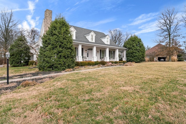 cape cod-style house featuring a porch and a front lawn