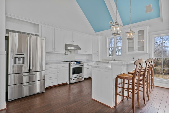 kitchen featuring extractor fan, white cabinets, dark hardwood / wood-style flooring, hanging light fixtures, and stainless steel appliances