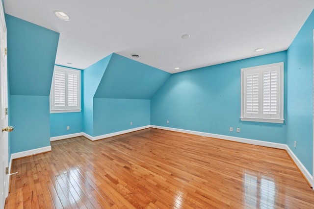 bonus room featuring vaulted ceiling and light hardwood / wood-style floors