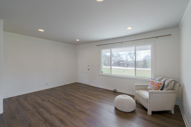 sitting room with dark wood-type flooring