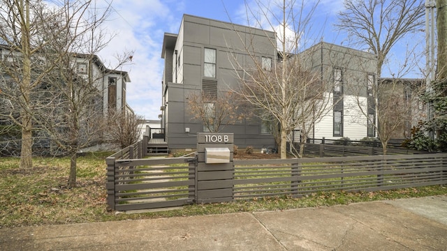 view of building exterior with a fenced front yard