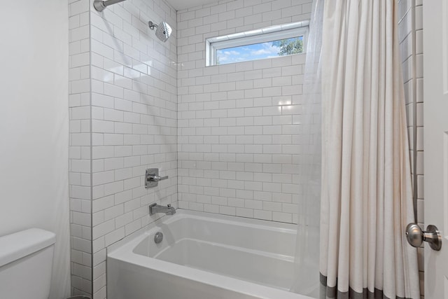 bathroom with shower / tub combo and toilet