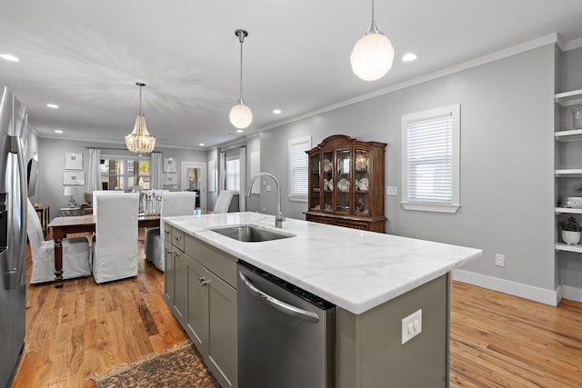 kitchen featuring sink, gray cabinetry, hanging light fixtures, stainless steel appliances, and an island with sink