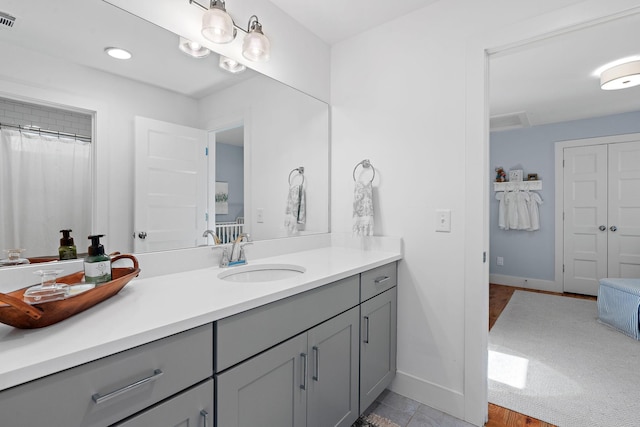 bathroom featuring vanity and curtained shower