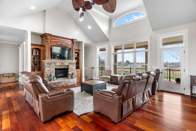 living room with dark hardwood / wood-style flooring, crown molding, and a wealth of natural light