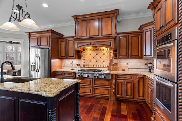 kitchen featuring pendant lighting, sink, crown molding, appliances with stainless steel finishes, and light stone countertops