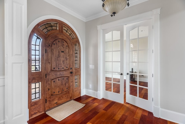 entrance foyer with ornamental molding and dark hardwood / wood-style floors