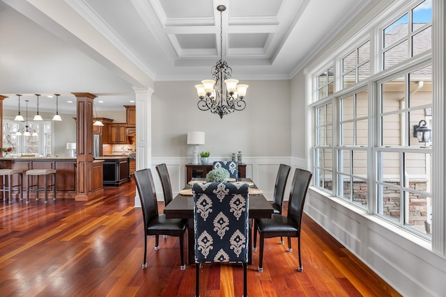 dining space featuring dark wood-type flooring, ornamental molding, coffered ceiling, and decorative columns