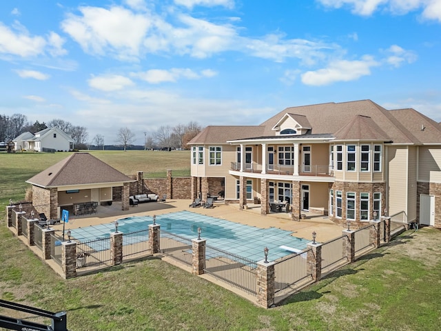 view of pool with exterior bar, a patio area, a lawn, and an outdoor kitchen