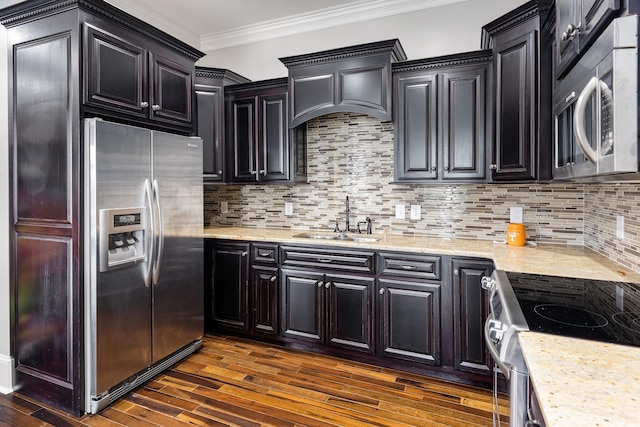 kitchen featuring sink, crown molding, tasteful backsplash, appliances with stainless steel finishes, and dark hardwood / wood-style floors