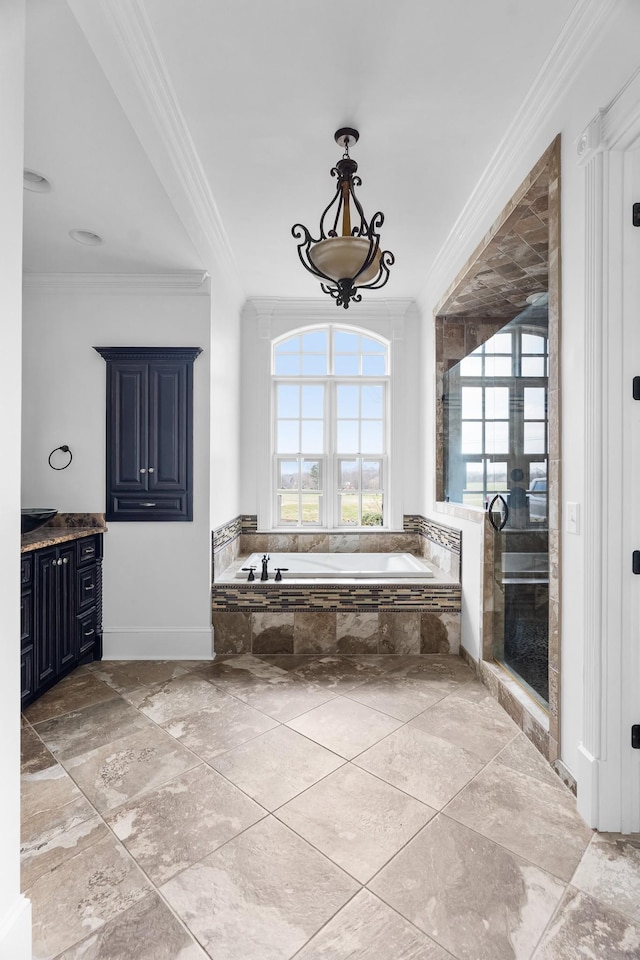 bathroom featuring vanity, crown molding, and separate shower and tub