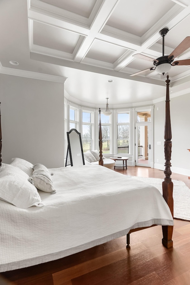 bedroom featuring coffered ceiling, ornamental molding, ceiling fan, beam ceiling, and hardwood / wood-style floors