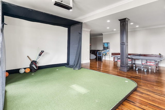 rec room with decorative columns, crown molding, golf simulator, and dark hardwood / wood-style flooring