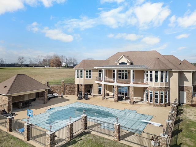 view of pool featuring a diving board and a patio