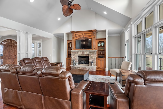 living room featuring ornate columns, a fireplace, hardwood / wood-style floors, and a wealth of natural light