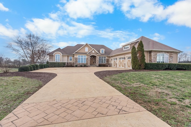 view of front of property featuring a garage and a front lawn