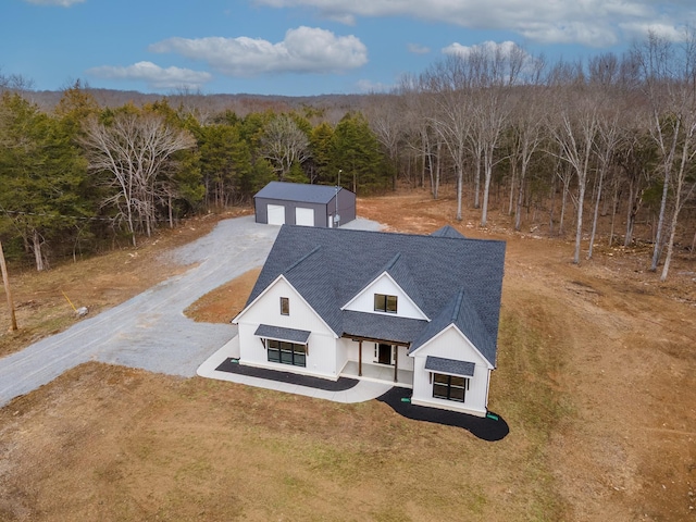 birds eye view of property featuring a wooded view