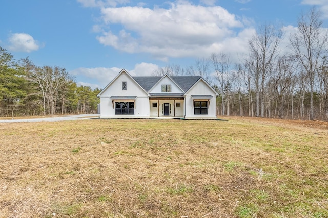 modern inspired farmhouse with a porch and a front yard