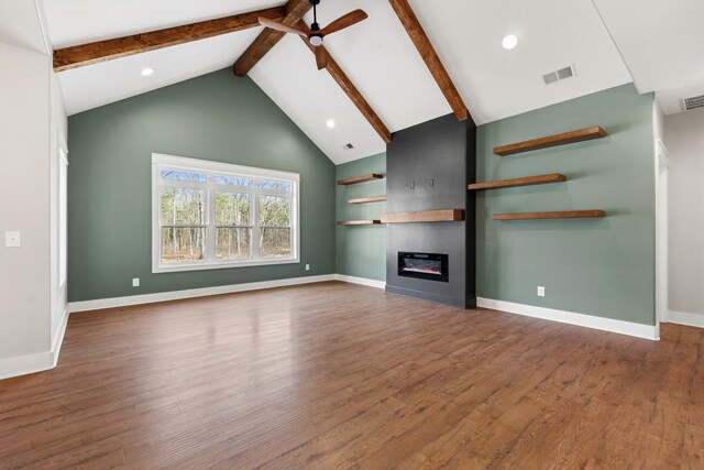 unfurnished living room featuring a large fireplace, wood finished floors, beam ceiling, and baseboards