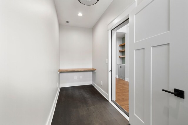 hall with dark wood-type flooring, recessed lighting, visible vents, and baseboards