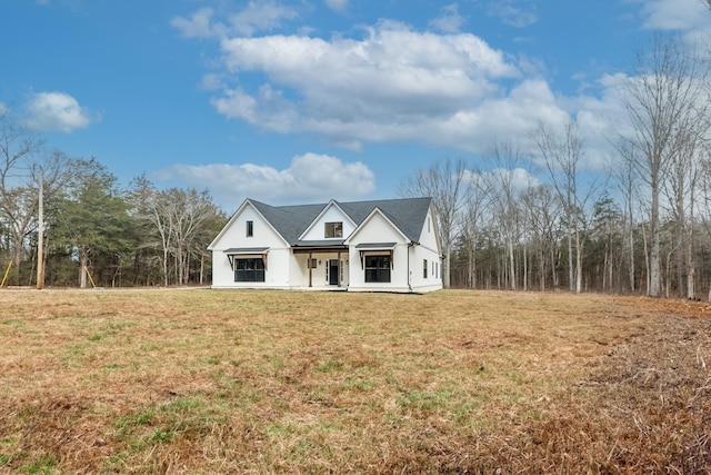 modern farmhouse style home with a porch and a front yard